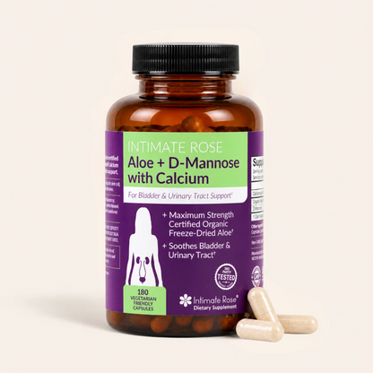 An amber supplement bottle labeled 'Intimate Rose Aloe + D-Mannose with Calcium' by Intimata Rose, shown on a light beige background with three beige capsules in front.