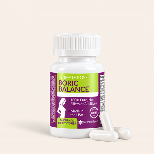 A white plastic bottle of Intimate Rose Boric Balance vaginal suppositories with three white capsules in front, set against a solid light beige background.