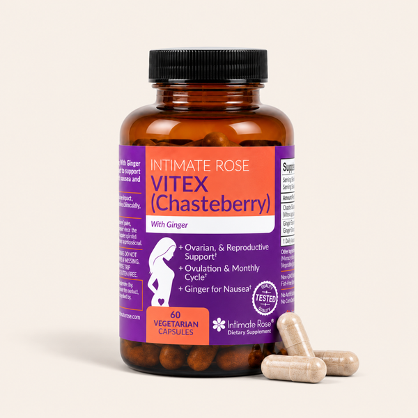 An amber glass bottle of Intimate Rose Vitex (Chasteberry) dietary supplements with a black cap, purple and orange label, and three beige capsules in the foreground, set against a solid off-white background.