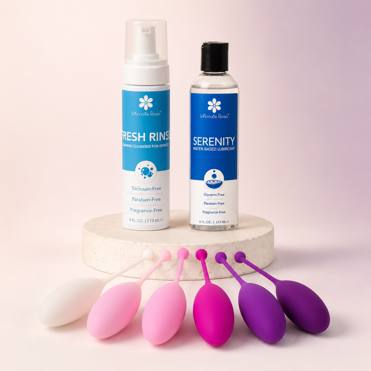 Intimate Rose Serenity lubricant and Fresh Rinse cleanser displayed with six progressive Kegel weights on a pedestal