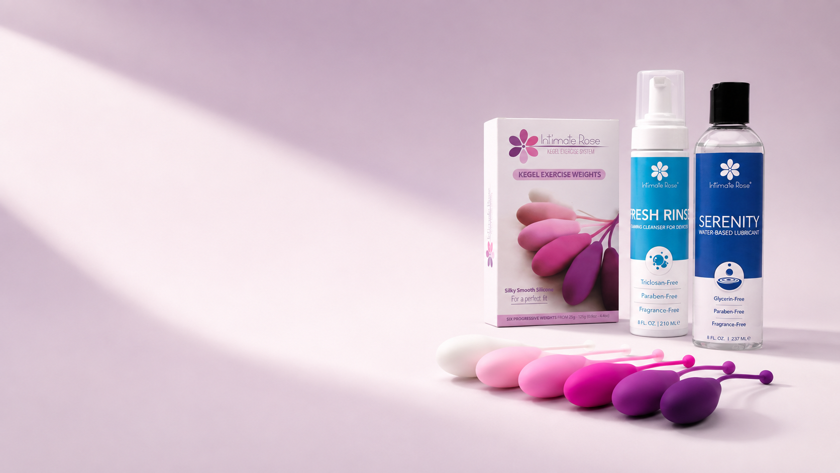 Pelvic Floor Strength Bundle with Kegel weights, Serenity lubricant, and Fresh Rinse cleanser on a pink background