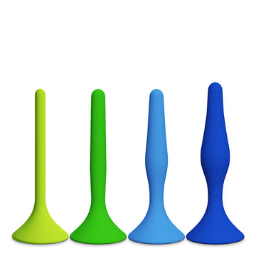 Four differently shaped, colorful silicone butt plugs in green and blue shades.